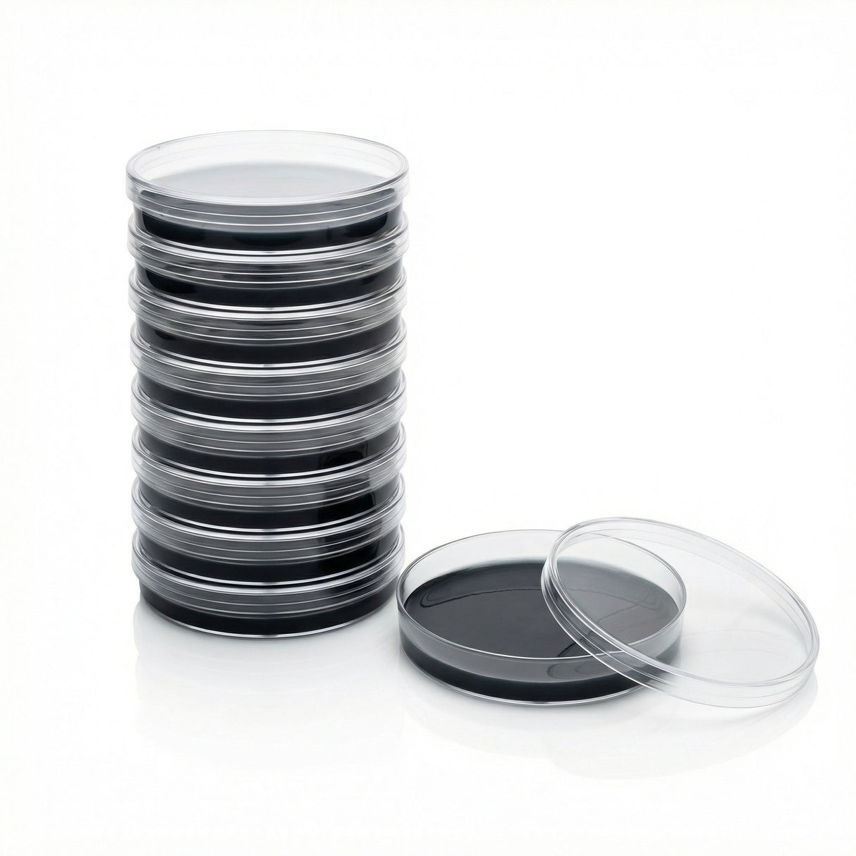 Stack of 10 black agar petri dishes with one open on a white background.