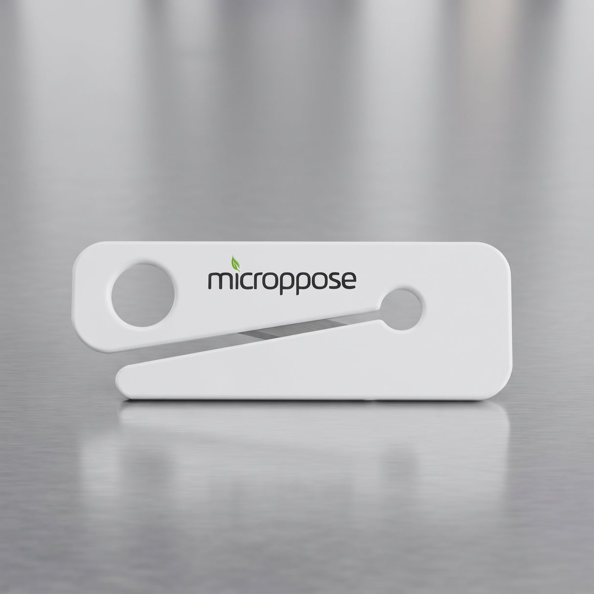 Microppose bag opener with recessed stainless steel blade on a stainless work surface