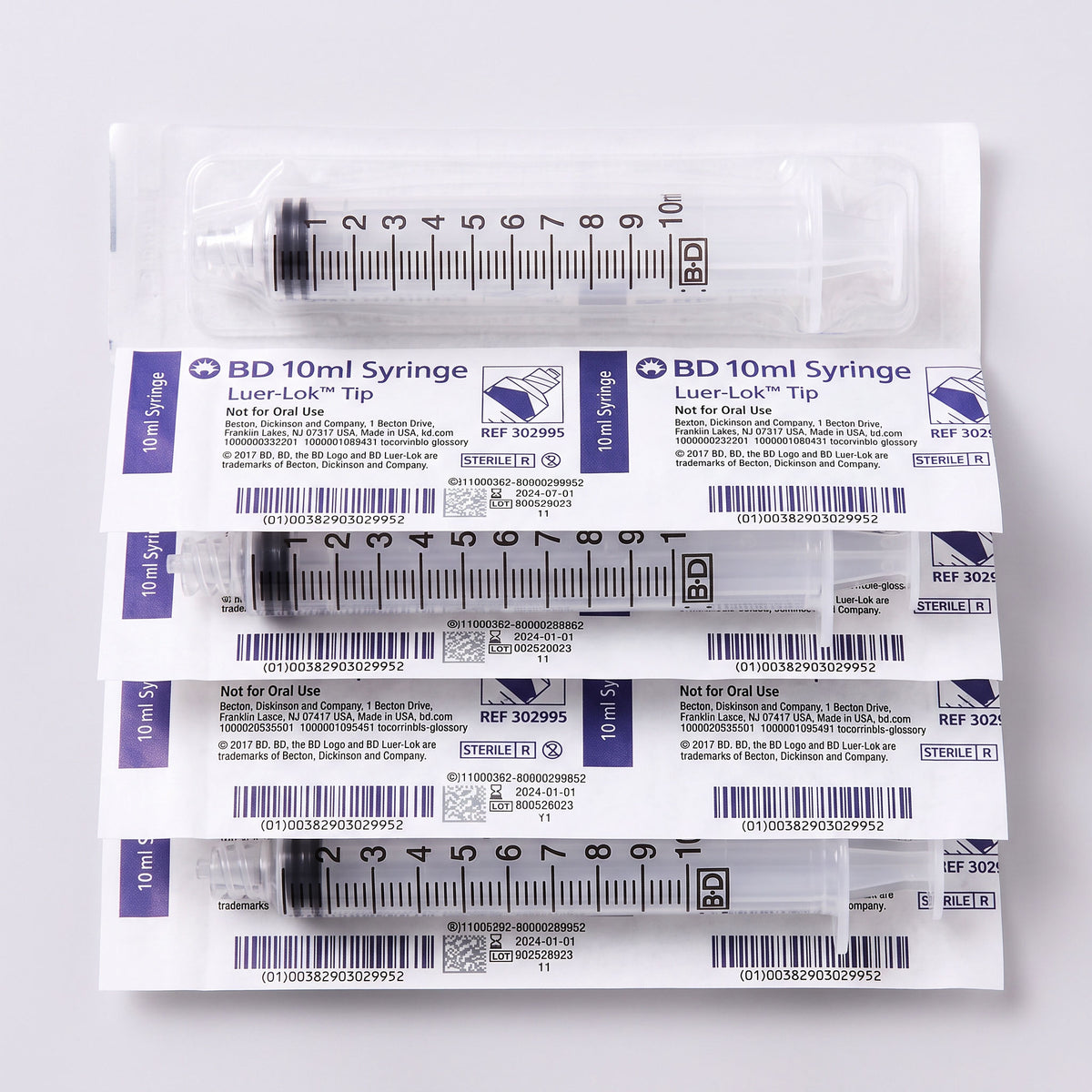 5 10cc luer lock syringes on white background