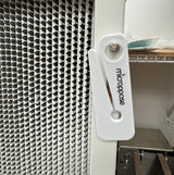 Microppose bag opener hanging by its hole on a laminar flow hood frame next to the HEPA filter