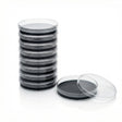 Stack of 10 black agar petri dishes with one open on a white background. 
