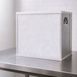 A white and silver Bonsai FFU Flow hood on a stainless steel work surface against a white brick wall background.