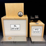 Two wooden Bonsai laminar flow hoods shown on a black background. The larger left unit is labeled XL 24"x18" and the smaller is 12"x12"