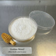 Container of white powder with a morel mushroom on a metallic surface, labeled 'Golden Morel (Morchella americana)'.