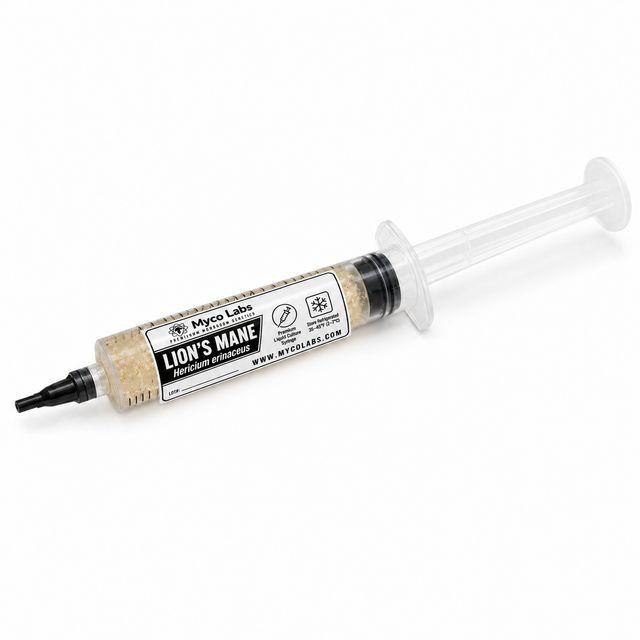 A syringe of Myco Labs Lion's Mane liquid culture showing the beige mycelium contents through a clear barrel with a white and black label.