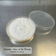 Maitake mushroom culture in a plastic container on a metallic surface with text label.