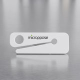 Microppose bag opener with recessed stainless steel blade on a stainless work surface