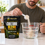 A man scooping Myco Labs Liquid Culture Premix into a pyrex measuring cup on kitchen counter. 
