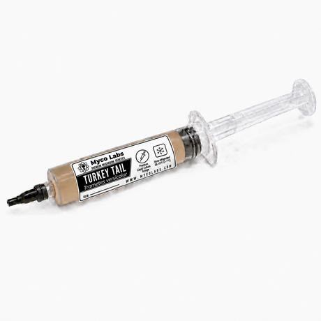 A syringe-style container of Myco Labs Turkey Tail liquid culture syringe, showing the beige malt medium inside a clear plastic syringe with a black cap, on a white background.