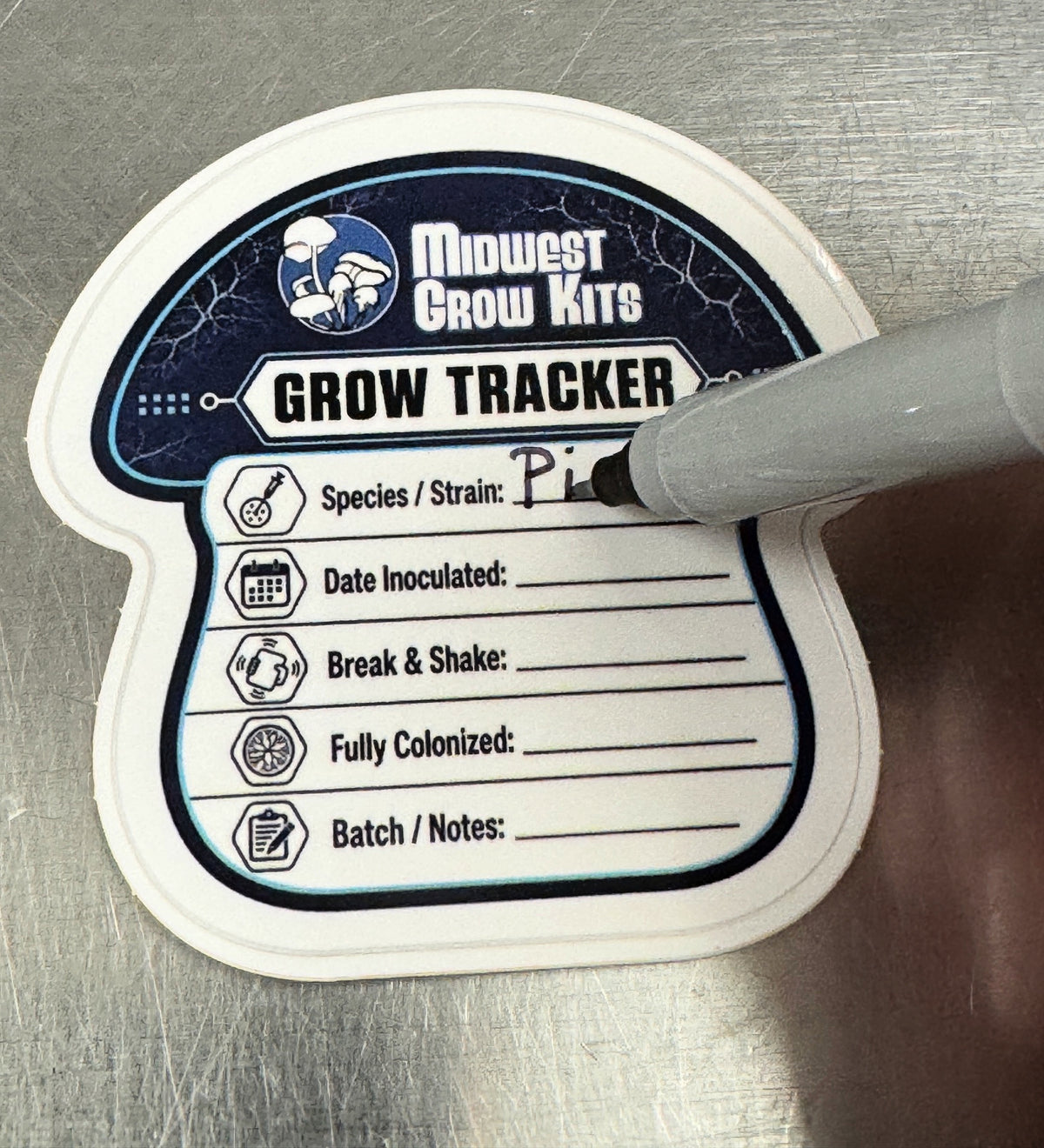 Writing on a reusable Grow Tracker label with the ultra-fine marker