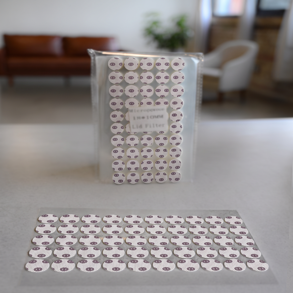 Microppose 0.3 micron self-adhesive lid filter stickers 18mm 28mm for jar lids and tissue culture on table. 