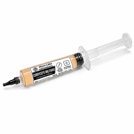 A syringe-style container of Myco Labs Cordyceps Militaris mushroom spore print, showing the beige spore material inside a clear plastic syringe with a black tip, on a white background.